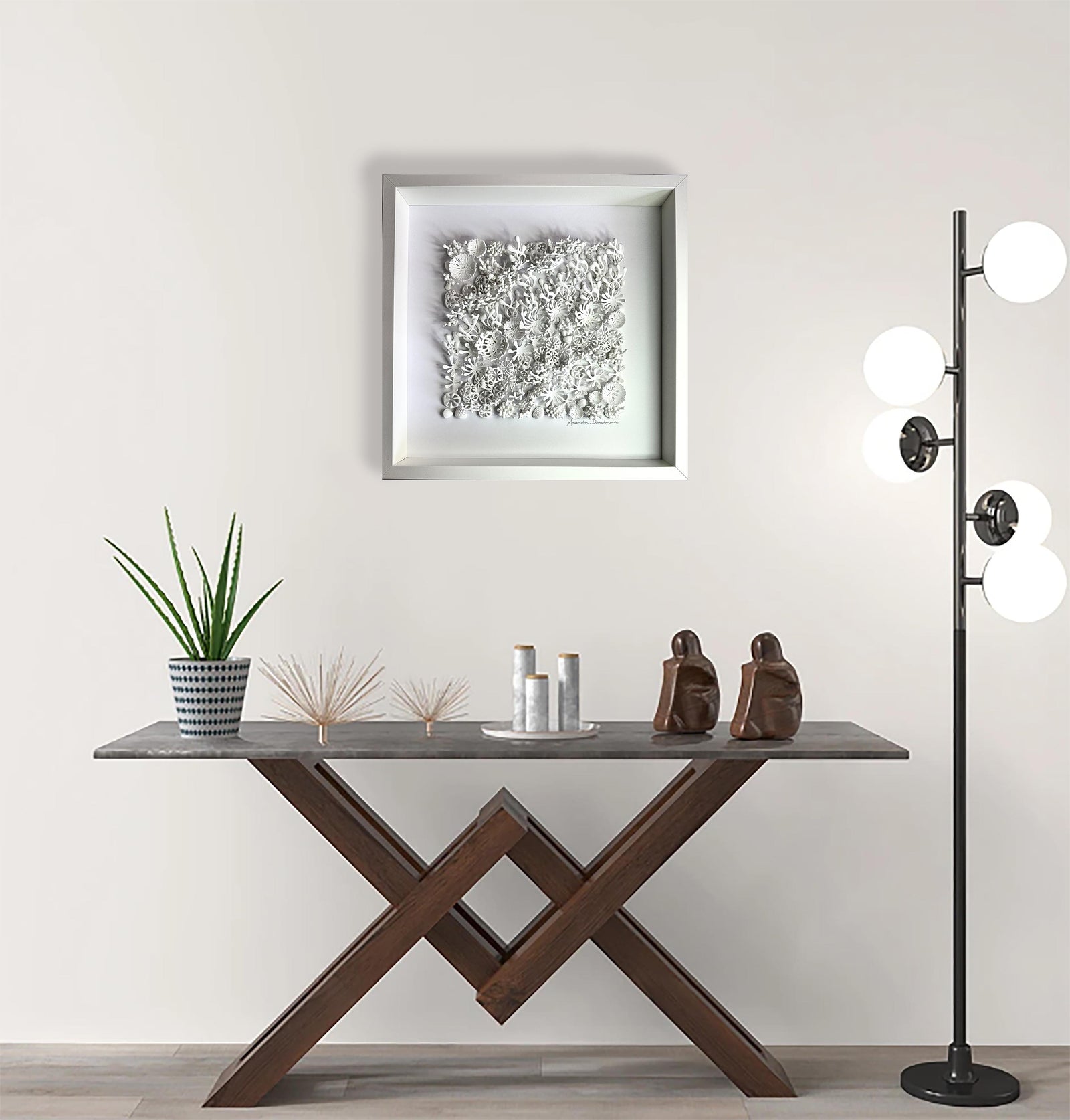 White sculptural coral relief wall art styled in a calm neutral living room